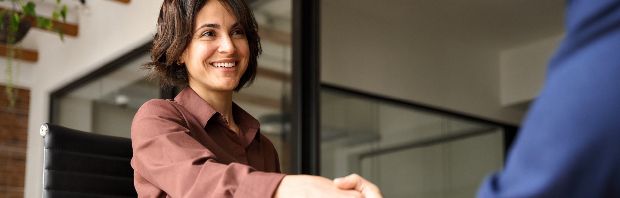 Smiling women shaking hands